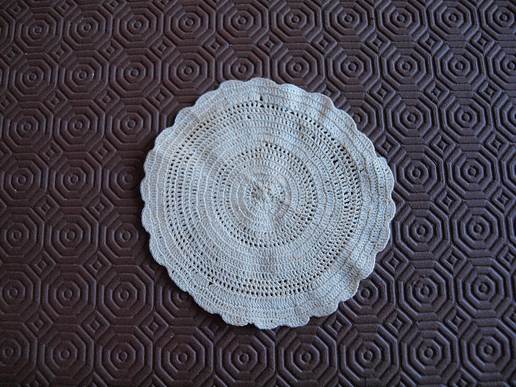 Renda de crochê circular sobre fundo escuro